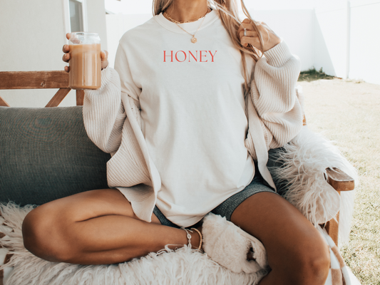 A light t-shirt with the word "Honey" written in all caps.